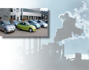 A fleet of 'green' cars; a silhouette of emissions at an industrial plant.