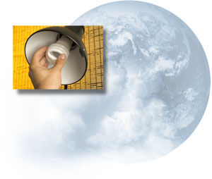 A CFL being screwed into a desk lamp; earth, as seen from space, partially covered by clouds.